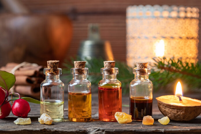 Christmas collection of essential oils with frankincense, wintergreen and candles