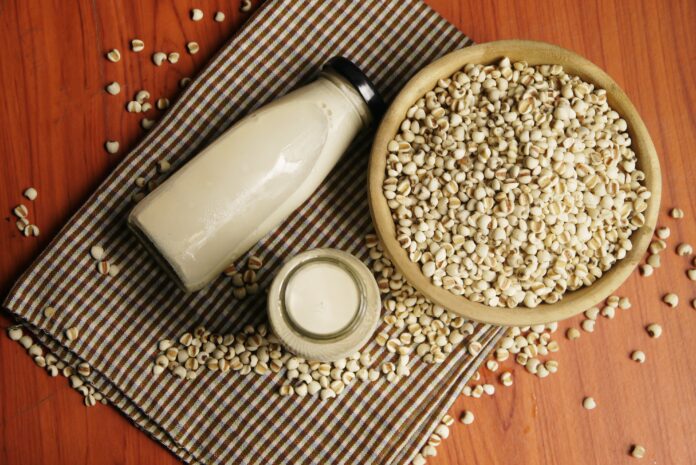 Soy milk and millet on table cloth from top view, selective focus.
