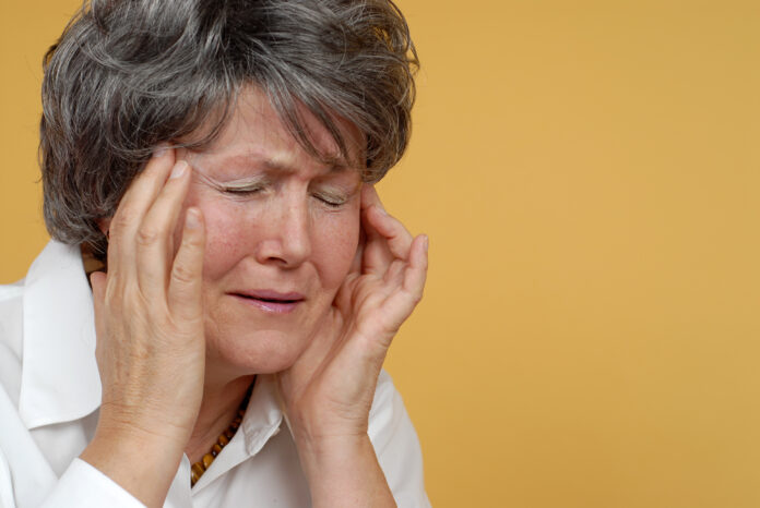 Painful headache portrait of an older woman