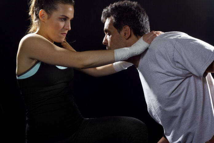 young fit woman fighting a man