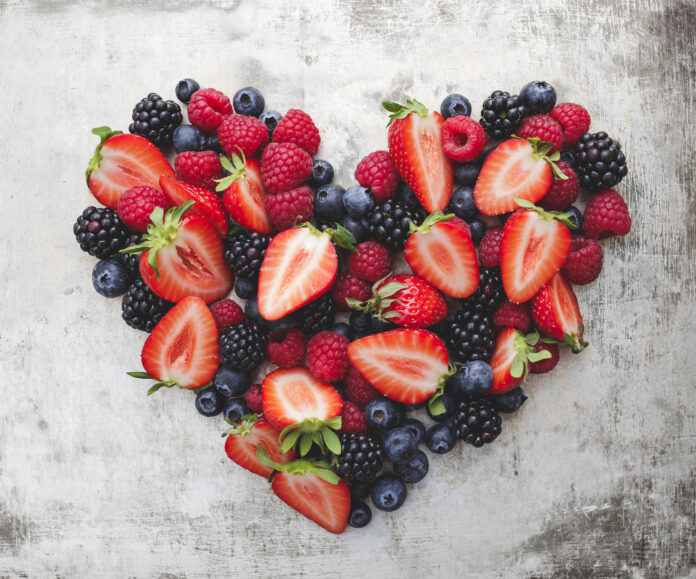 heart, formed from different berries like strawberries, blackberries, raspberries and blueberries