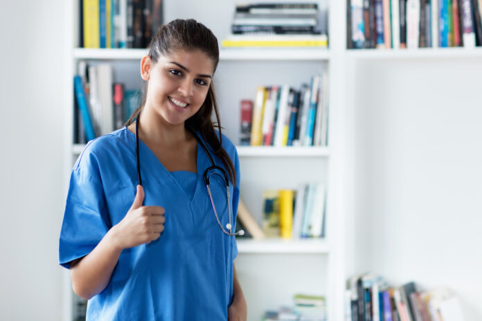 Optimistic young adult spanish female nurse or medical student at hospital