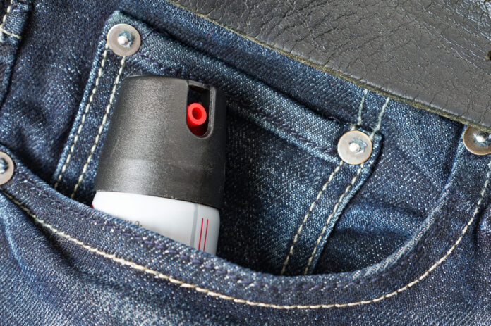 Tear gas or pepper spray in jeans pocket. Self defense tool.