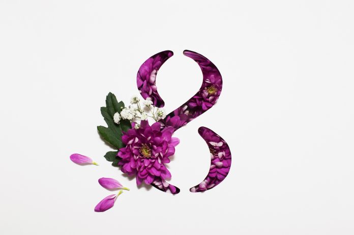 international Women's Day on March 8. Greeting card from March 8. The number eight is cut in white paper and filled with purple flowers