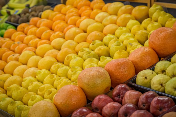 A display of fruit for sale at a market, with a shallow depth of field