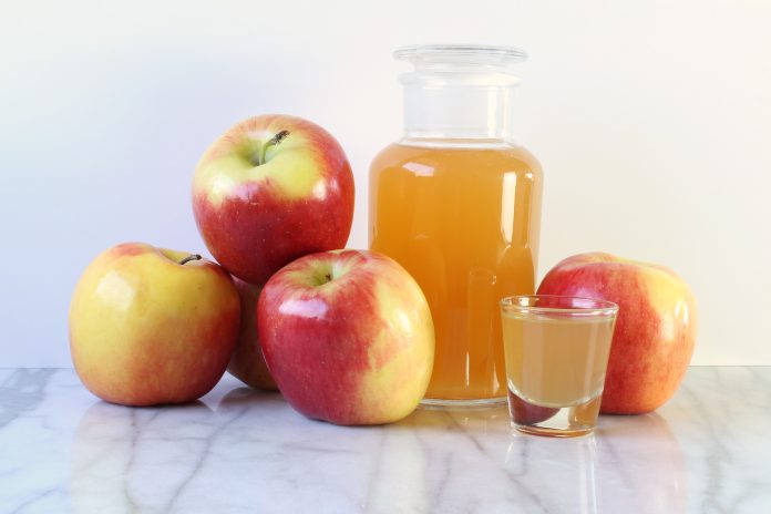 Apple cider vinegar and apples. Copy space.